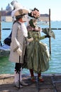 Venice, VE, Italy - February 13, 2024: couple of masked lovers with very elegant and luxurious clothes during the carnival