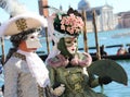 Venice, VE, Italy - February 13, 2024: couple of people with elegant noble clothes masked during the Venetian carnival