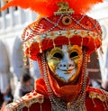 Venice, VE, Italy - February 13, 2024: golden mask and big red hat Royalty Free Stock Photo