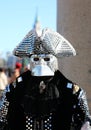 Venice, VE, Italy - February 13, 2024: Masked man wearing an original costume made of fine fabric and many mirrors reflecting Royalty Free Stock Photo