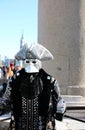 Venice, VE, Italy - February 13, 2024: Masked man wearing an original costume made of fine fabric and mirrors reflecting light Royalty Free Stock Photo