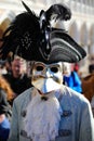 Venice, VE, Italy - February 13, 2024: masked person with big noise and black hat at Venetian Carnival