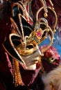 Venice, VE, Italy - February 13, 2024: person with a decorated ancient court jester mask at the Venetian carnival Royalty Free Stock Photo