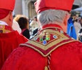 Venice, VE, Italy - February 13, 2024: priest with red cassock and precious stones ornament on the clerical cloak