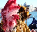 Venice, VE, Italy - February 13, 2024: Venetian Mask at the Venice Carnival and sea of lagoon with St George Church Royalty Free Stock Photo