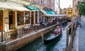 Venice. A Venetian Gondola navigates the narrow canals with tourists Royalty Free Stock Photo