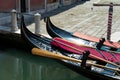 Moored Gondolas by a Venetian Canal\'s Edge Royalty Free Stock Photo