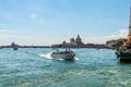 Boats Cruising on the Grand Canal with Santa Maria della Salute Royalty Free Stock Photo