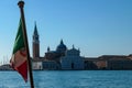 Venice - Waving Italian flag with scenic view church on the Island of San Giorgio Maggiore Royalty Free Stock Photo
