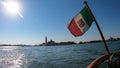 Venice - Waving Italian flag with scenic view church on the Island of San Giorgio Maggiore Royalty Free Stock Photo