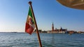 Venice - Waving Italian flag with scenic view church on the Island of San Giorgio Maggiore Royalty Free Stock Photo