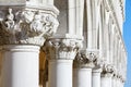 Venice, white capital sculptures of Doge palace colonnade in Italy Royalty Free Stock Photo