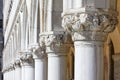 Venice, white capital sculptures of Doge palace colonnade in Italy