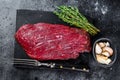 Venison raw steak from wild meat. Black background. Top view