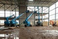 Four aerial platforms at a construction site