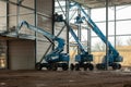 Three aerial platforms at a construction site Royalty Free Stock Photo