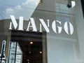 View on storefront window with logo and lettering of international fashion group Mango