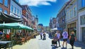 View on shopping pedestrian street with old traditional houses and cafe restaurants in dutch town in summer Royalty Free Stock Photo