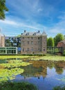 Beautiful dutch castle hotel with idyllic water pond in summer