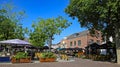 Market square with outdoor gastronomy in summer in dutch town, green linden trees