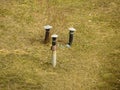 Vent pipe sticks out of the ground. Pipe for ventilation of the cellar. A rusty pipe sticks out of the ground on the river bank on