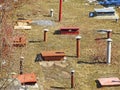 Vent pipe sticks out of the ground. Pipe for ventilation of the cellar. A rusty pipe sticks out of the ground on the river bank on