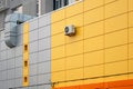 Ventilated yellow building facade of metal cassettes. Royalty Free Stock Photo