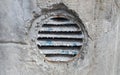 Ventilation hole in concrete. Metal industrial round ventilation cover. Rusty and dirty old round ventilation frame with Royalty Free Stock Photo