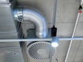 Ventilation system mounted on the concrete ceiling, ventilator, tube and a lamp