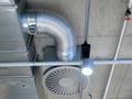 Ventilation system mounted on the concrete ceiling, ventilator, tube and a lamp Royalty Free Stock Photo