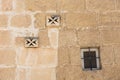 Ventilator on a stone wall. Maltese cross