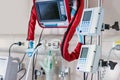 Ventilators and vital sign monitors next to Intense Care Unit bed