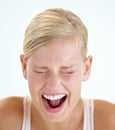 Venting her emotions. A frightened young woman shrieking with her eyes closed. Royalty Free Stock Photo