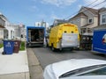 Contractor\'s work trucks blocking a small street in a residential neighborhood Royalty Free Stock Photo