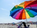 Ventnor,New Jersey - May,2022: A large colorful beach umbrella on a crowded beach
