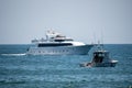 The luxury motor super yacht `Surfrider` arrives at port in front of the Harbor Patrol boat. Royalty Free Stock Photo