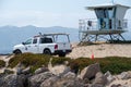 Ventura, California, USA - June 19, 2020: A Harbor Patrol vehicle at Ventura Harbor patrols the beach and shore near a lifeguard