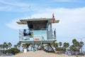 A lifeguard at Ventura Harbor watches from inside a lifeguard tower at a breakwater