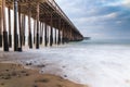 Ventura Pier, early morning. Beach sand and rocks; smooth ocean and colored sky. Royalty Free Stock Photo