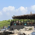 Veranda with sea view cafe, people looking sea panorama. Punta della suina, Salento, Italy