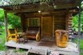 The veranda of a small wooden bathhouse on the porch of which there are benches and a large old bath. Rest and health in nature Royalty Free Stock Photo