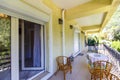 Verandah with wicker furniture and iron railings on the first floor of a multi-storey building Royalty Free Stock Photo