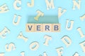 Verb concept in English grammar and learning class lesson. Wooden blocks typography word flat lay Royalty Free Stock Photo