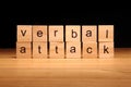 Verbal attack words written on wood cube