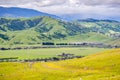 Verdant hills and valley in south San Francisco bay area on a rainy spring day; hiking trail visible in the foreground; San Jose, Royalty Free Stock Photo