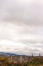 Verical shot of the cityscape of Edinburgh in autumn and the clouded sky