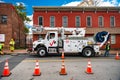 Verizon workmen lowering cable into a manhole (digital composite). Verizon special equipment for Internet debugging