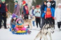 Little kid on snow tubing with sled dog Royalty Free Stock Photo