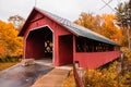 Vermont covered bridge surrounded by colorful fall foliage. Royalty Free Stock Photo