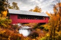 Vermont covered bridge surrounded by colorful fall foliage.